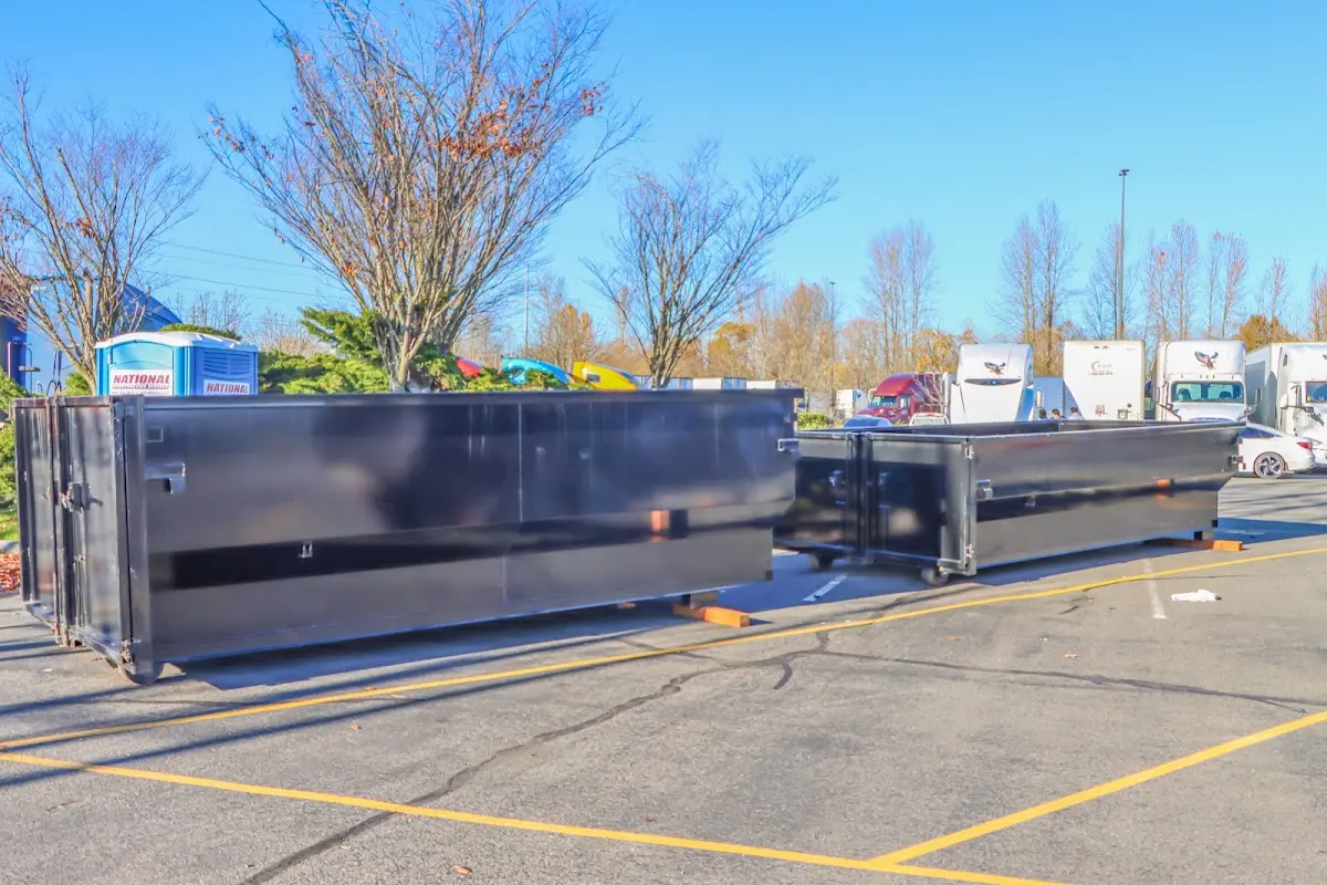 Professional dumpster rental service with roll-off container on residential driveway in Clearlake